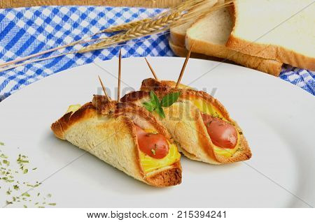 Toasted Hot Dogs and Cheese on white dish and wheat with fresh toast on wooden background