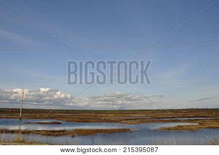 Cold autumn sky over rivers and lakes. Travelling. Tundra