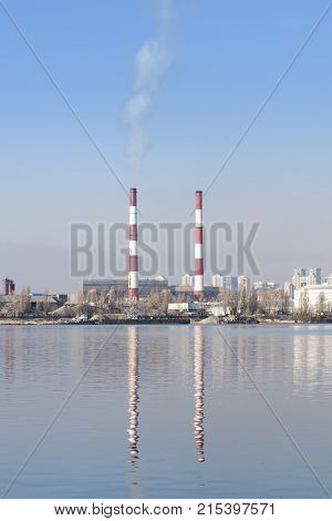 Two Striped Pipes Smoke Against A Blue Sky Vertical