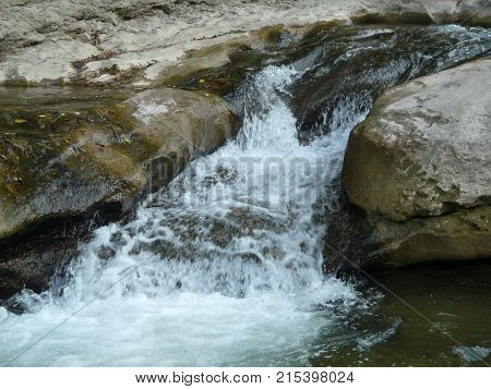 Waterfalls in the mountains of the North Caucasus surrounded by beautiful autumn nature