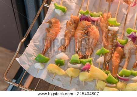 Homemade Skewer With Delicious Grilled Shrimps On Parchment Paper