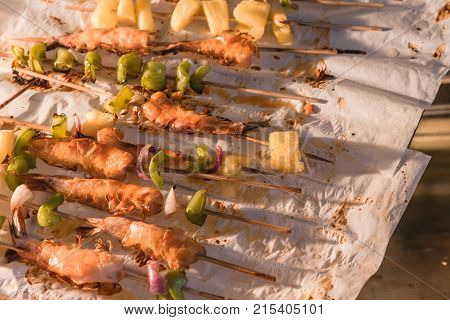 Homemade Skewer With Delicious Grilled Shrimps On Parchment Paper