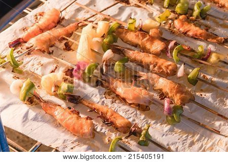 Homemade Skewer With Delicious Grilled Shrimps On Parchment Paper