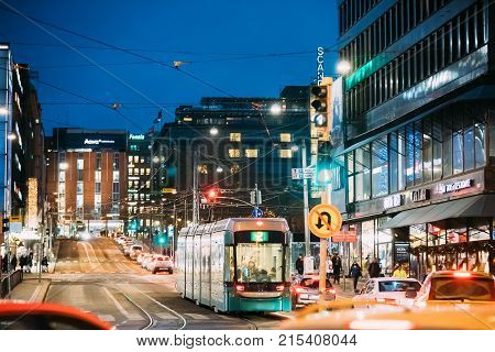 Helsinki, Finland - December 7, 2016: Tram Departs From A Stop On Kaivokatu Street In Helsinki. Night View Of Kaivokatu Street In Kluuvi District In Evening Or Night Illumination.