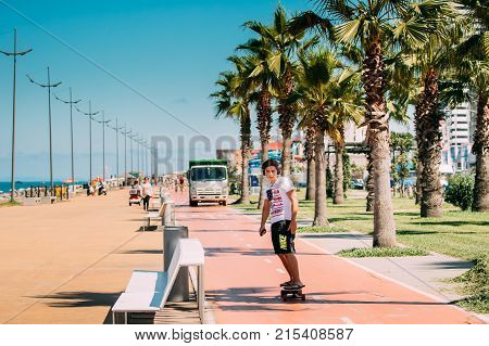 Batumi, Adjara, Georgia - September 9, 2017: Young Man Skateboarding On Bicycle Ln Lane In Seafront Promenade