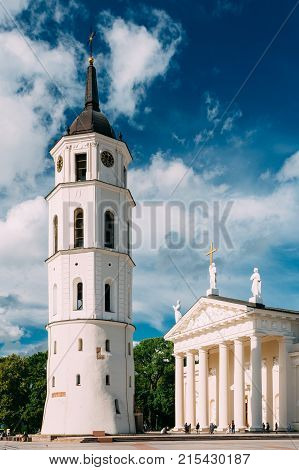 Vilnius, Lithuania. View Of Bell Tower And Facade Of Cathedral Basilica Of St. Stanislaus And St. Vladislav On Cathedral Square, Famous Landmark, Showplace In Sunny Summer Under Blue Sky With Clouds.