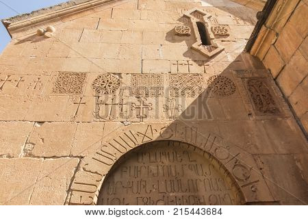 Crosses and other marks scratched on the walls of buildings in the Noravank monastery in Armenia
