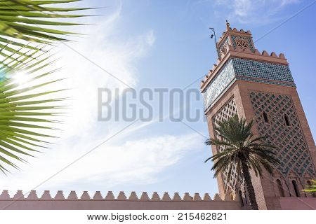 mosque in marrakesh with palm and blue sky travel tourism destination