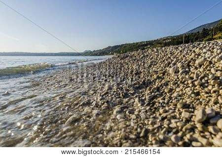 close-up at sunset of surf on pebble beach lourdata on the island of kefalonia close to the city of argostoli main town of the island
