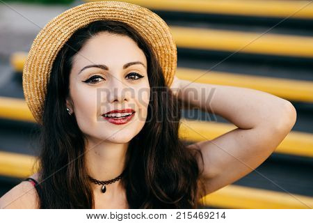 Pretty Woman With Dark Hair, Shining Eyes And Red Painted Lips Looking Confidently And With Smile At