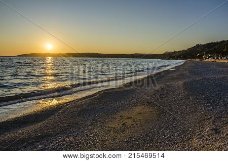 fall of sun in the beach of lourdata we see the coast line and the marine stroll