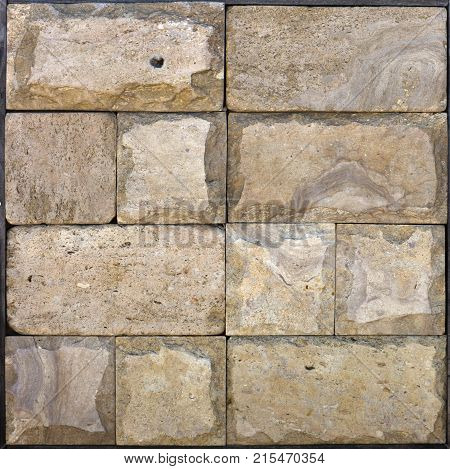 Stone wall texture, travertine tiles facing stone background