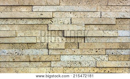 Stone wall texture, travertine tiles facing stone background