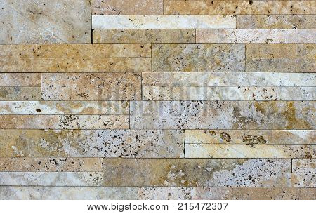 Stone wall texture, travertine tiles facing stone background