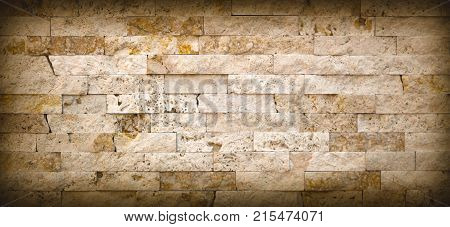 Stone wall texture, travertine tiles facing stone background