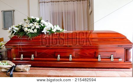 closeup shot of a colorful casket in a hearse or chapel before funeral or burial at cemetery