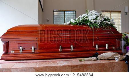 closeup shot of a colorful casket in a hearse or chapel before funeral or burial at cemetery