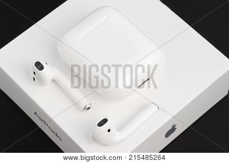 UFA RUSSIA - OCTOBER 20 2017: AirPods wireless headphones developed by Apple Inc. AirPods box and charger.