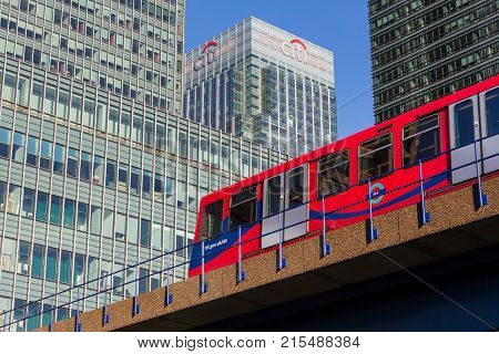 LONDON, UK - JANUARY 30, 2016: Docklands Light Railway train runs underneath sign for Citibank building in Canary Wharf, London