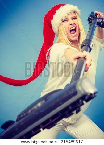 Angry Girl In Santa Helper Hat With Vacuum Cleaner