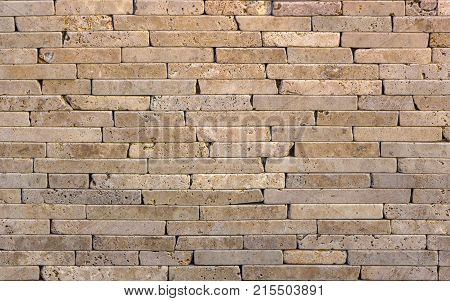 Facing tile from travertine with a smooth surface texture