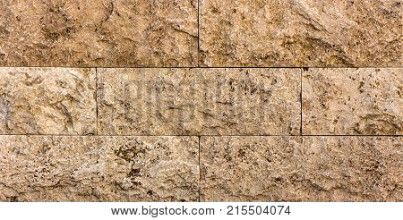 Facing tile from travertine with a smooth surface texture