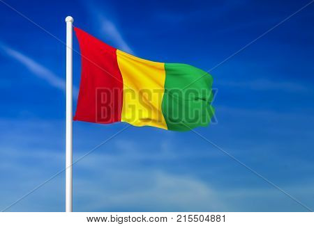 Waving flag of Guinea on the blue sky background - 3D rendered