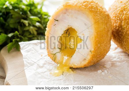 Chicken Kiev cutlets with parsley leaves and butter.
