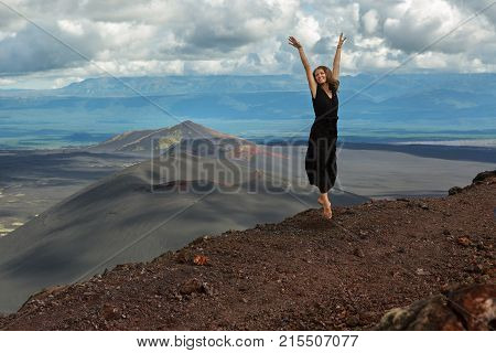 Kamchatka Peninsula, Russia - August 20, 2016: Model is posing on top of Hiking trail climb to the North Breakthrough Great Tolbachik Fissure Eruption 1975