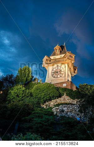 Graz, Austria - August 11, 2017: Low angle view of Uhrturm clock at night