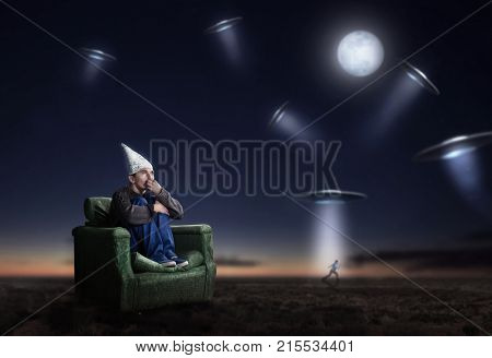 Stupid man in tinfoil helmet at night, UFO phobia