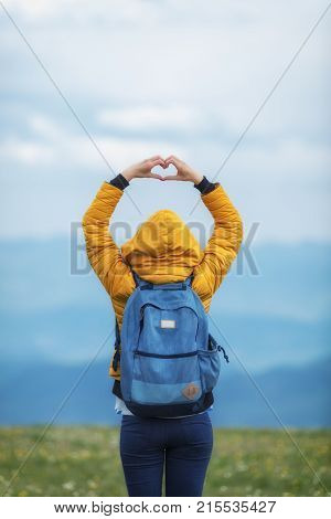 Girl holding a heart - shape in the nature.