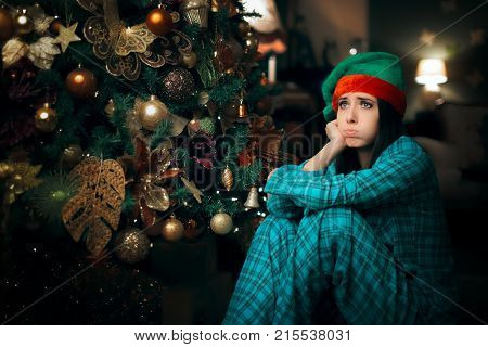 Bored Girl Waiting for Santa Claus Next To Her Christmas Tree