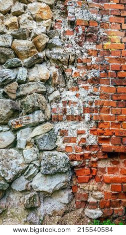 Stone old wall from huge blocks. Background stones. Beautiful textured vintage antique background. Old masonry and a new brick with stone.
