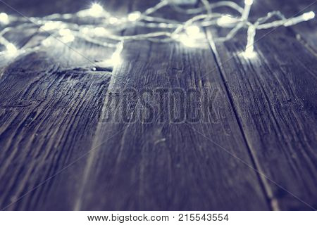 Glowing Bokeh Background With Empty Wooden Table. Christmas Background