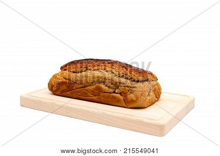 A homemade plumcake standing on a wooden board with a white background