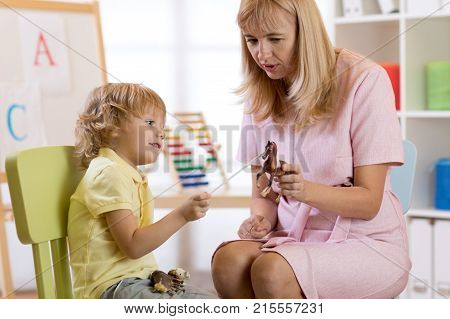 Child boy talking with psychologist. Preschool education.