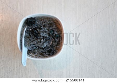 Chao Guay with Grain seeds in bowl on wood table and have copy space for design in your work.