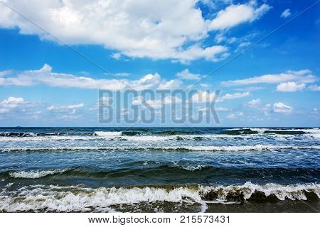 Seascape. Tidal wave blue sky with clouds and an endless horizon