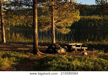 Picnic table by lake in evening light in Idre, Sweden during summer