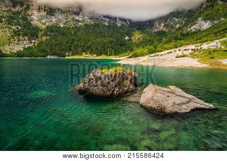Turquoise alpine lake and high mountains with green pine forest, Lake Hinterer Gosausee, Salzkammergut, Austria, Europe