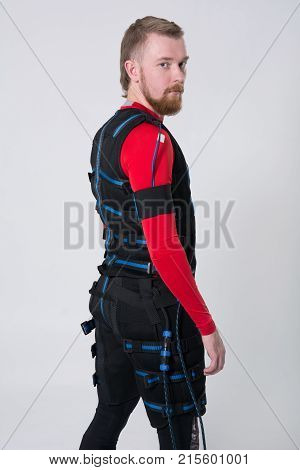 Red-haired Man With A Beard In Electric Muscular Suit For Stimulation