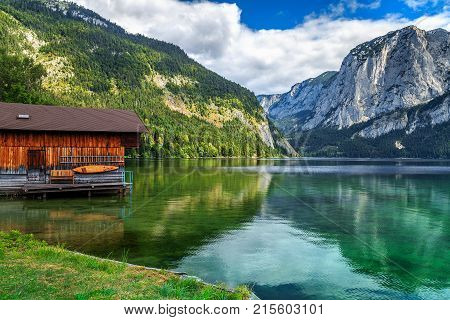 Wooden boat dock with high rocky mountains in background, Altaussee, Salzkammergut, Austria, Europe