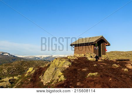 Mountain cabin for survival, close to Trolltunga in Norway. Blue sky and sunlight