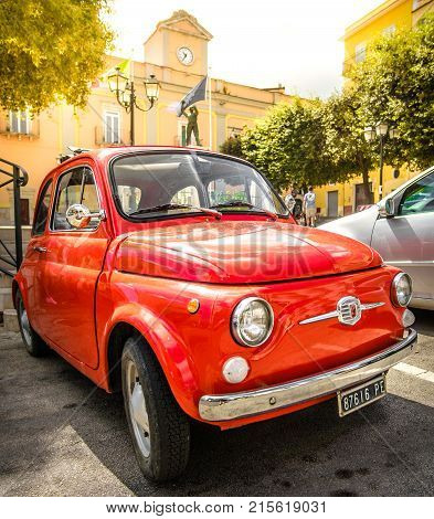 vintage red fiat 500 car parked in the main square of Peschici in Apulia 14 Jul 2017 - Italy