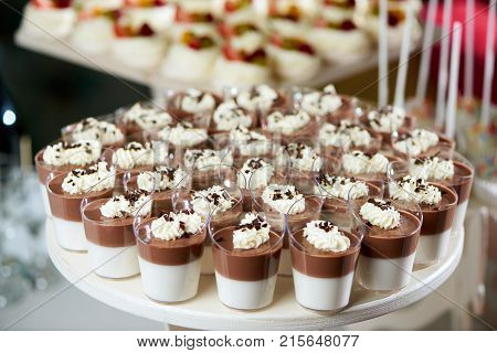 Close up shot of delicious chocolate jellies decorated with whipped cream and chocolate crust copyspace layout background menu restaurant confectionery party served.
