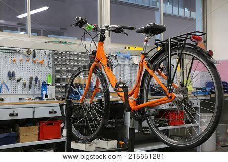 Bicycle Repair Workshop With One Orange Bike