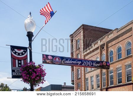 BUCHANNON, WEST VIRGINIA - AUGUST 13, 2016: Flags fly by bicentennial banner across Main Street in Buckhannon West Virginia