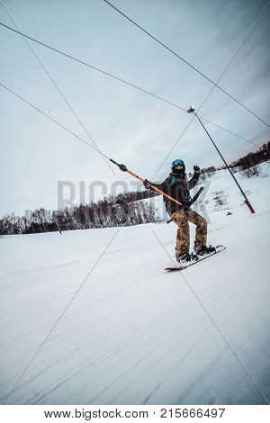 Snowboarder In A Black Helmet Riding On A Snowy Track.
