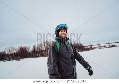 Snowboarder In A Black Helmet Riding On A Snowy Track.